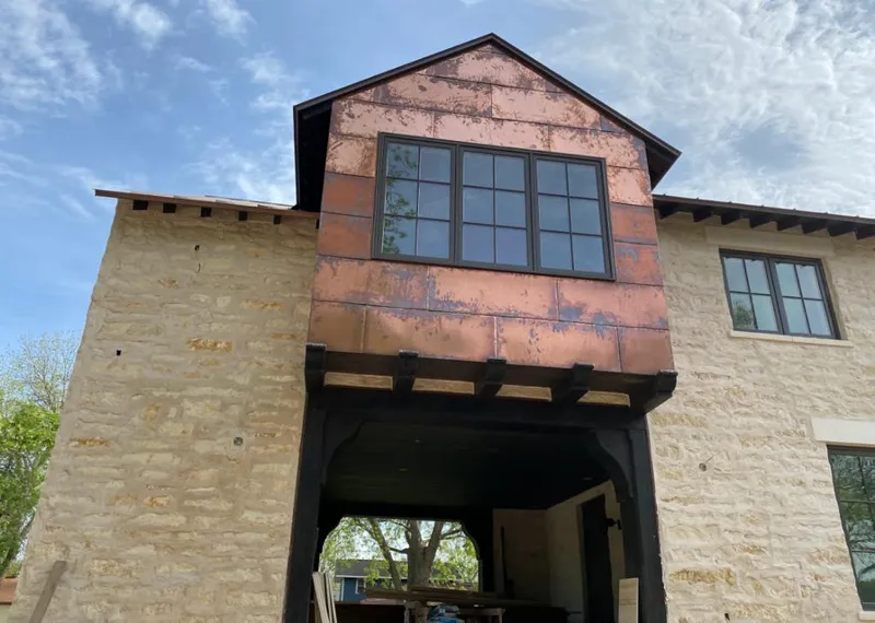 Copper metal panel facade on a stone building for Metal Roof Coating in Yankton